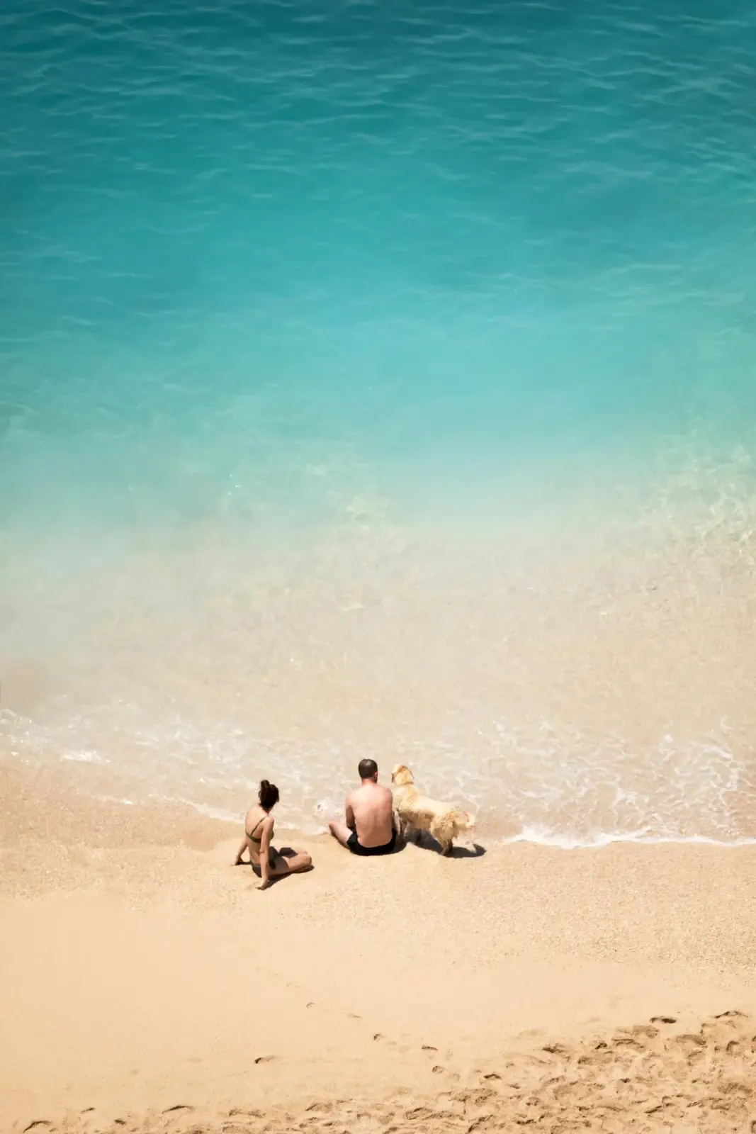 Two people seated together on an Aruba beach