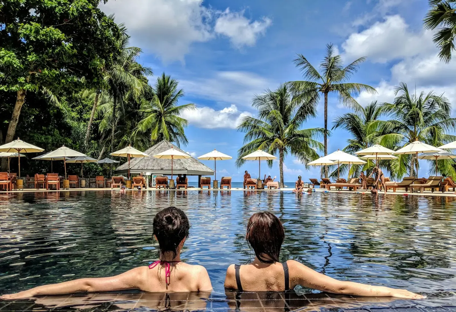 Guests sunbathing together at a resort pool