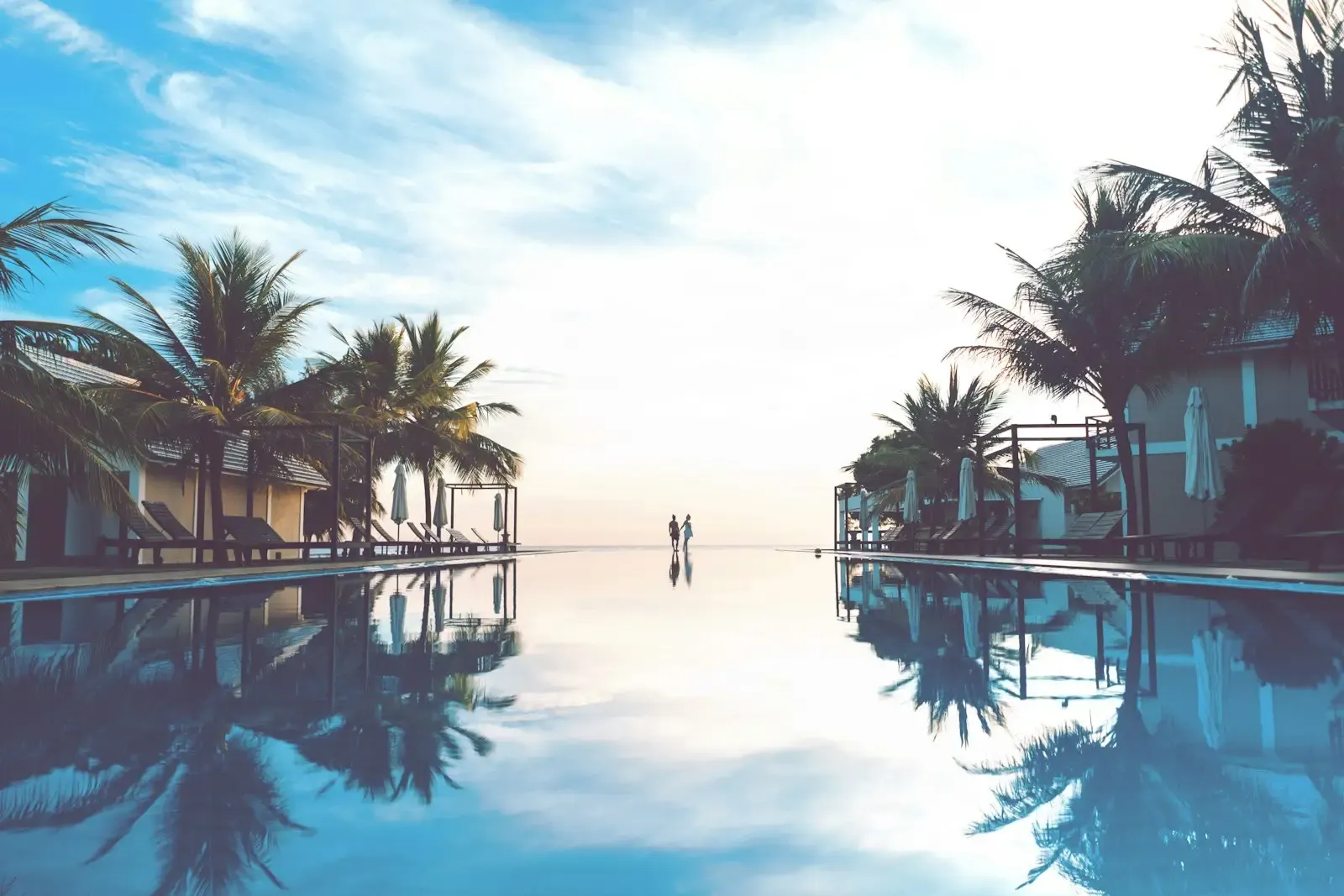 A couple chats poolside together at a resort in Aruba