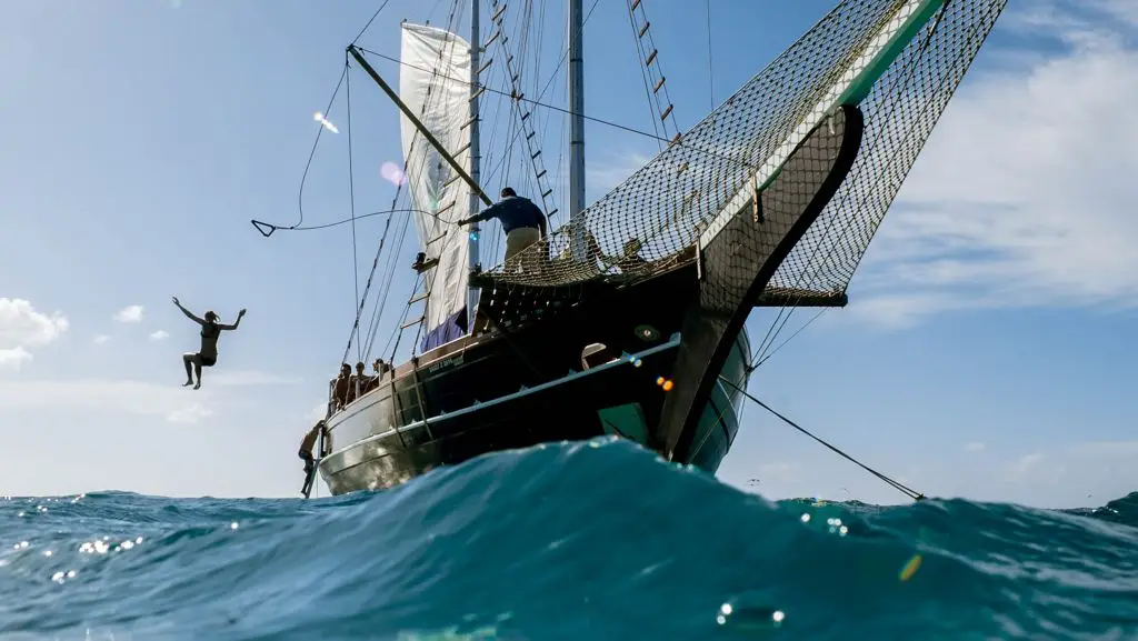 A guest jumps from the Flagship Aruba schooner into the ocean